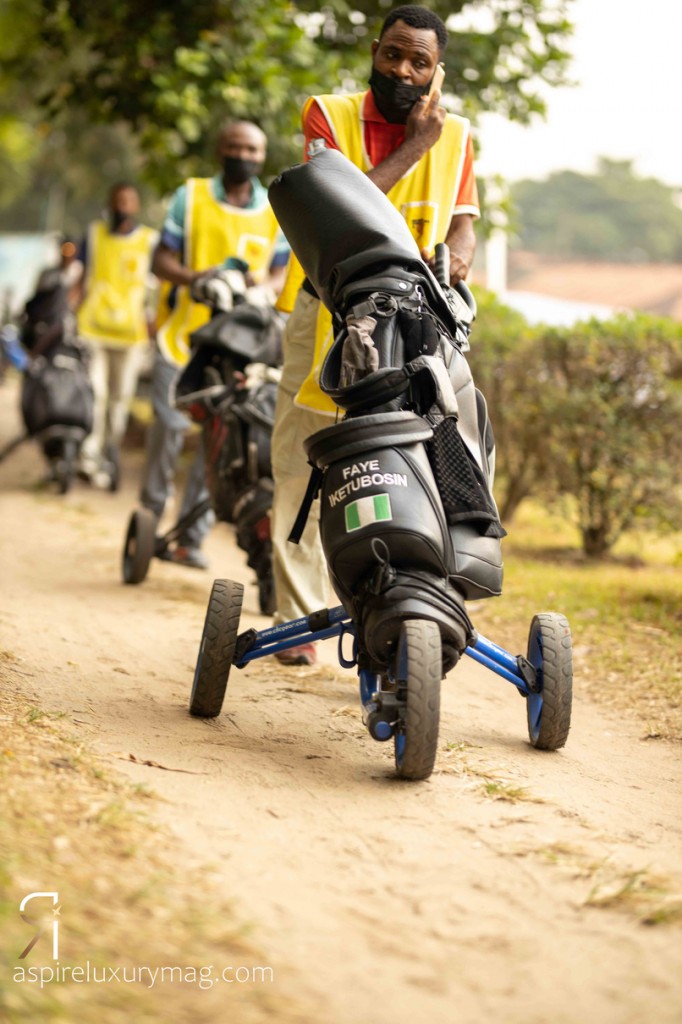 The caddies moving towards the golf course